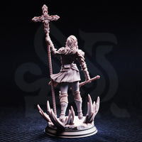 Unpainted grey resin miniature of Sara Rosewood rear view — showing long flowing hair, chainmail back detail, cloak in motion, and the crystal shard base from behind with the holy staff raised overhead