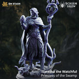 Saratha the Watchful by DM Stash — rear view showing the broad sweep of a heavily textured fabric cloak with fur collar detail, staff with trident finial raised behind, and a detailed root-covered scenic base beneath.