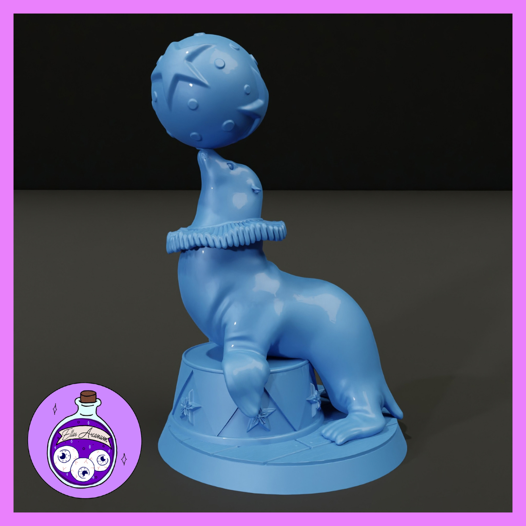 A sea seal seated upright on a star-decorated circus plinth, balancing a large textured ball on its snout, wearing a ruffled performer's collar. Sculpt by Ella's Arcanum Minis.