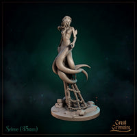 Merfolk miniature with long flowing hair coiled around a ship's mooring post, scaled tail looping through thick rope, scattered rocks and sea debris on the base. Sculpt by Great Grimoire.