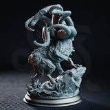 Shogdog by DM Stash viewed from the left — deep segmented skin folds and overlapping ridges visible across torso and limbs, tentacles spiralling upward, cluster eyes along flanks, broken cobblestone base.