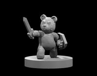 Grey resin render of Sir Plush the Teddy Bear Guardian miniature — a rounded teddy bear figure with a serene expression advancing forward, holding a wooden sword aloft in his right hand and gripping a chunky wooden shield in his left, sculpted with soft fur texture, mounted on a plain round base, 32mm scale
