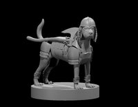 Armoured dog miniature wearing an Egyptian nemes helmet and chest harness with buckled strapping, a blade scabbard mounted on its back, and leg wraps on all four legs. Tail raised. Sculpt by MZ4250.