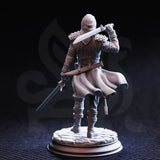 Rear three-quarter render of the Mafia Brigand 1 miniature — showing the figure in a chainmail coat with a flowing textured duster, dual swords raised mid-stance, and a belt with pouches and a baton. Face-wrap and sculpted pauldrons visible. Unpainted grey resin on cobblestone base, 32mm scale.