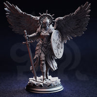 Painted display photograph of Soleria the Judge miniature with wings — armoured female celestial figure with dark feathered wings spread wide, longsword resting on rubble base, ornate relief shield on left arm, spiked wheel halo, photographed against a dark moody background showing fine sculpt and armour detail