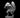 Squirrelfolk Rogue miniature by MZ4250, crouched low, pointing with one hand and clutching a keyboard in the other, wearing a spy hat, large fluffy tail fanned behind.