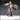Skeleton warrior in full riveted armour holding a large battle-axe raised over the right shoulder and gripping a round shield, wearing a close-fitted skull helm and a long flowing cloak. Sculpt by Novaminis.