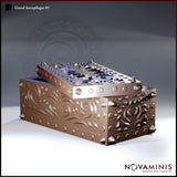 Ornate box-form sarcophagus with a partially open spike-covered lid revealing a hollow interior, sides decorated with deep-cut floral scroll filigree and conical corner studs. Sculpt by Novaminis.