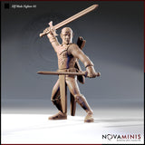 32mm resin miniature render of an elven male fighter in chainmail and studded leather armour, dual-wielding two longswords — right sword raised overhead in a striking pose, left sword extended forward — with ornate flame-motif chest detailing and a focused, determined expression. Unpainted render by Novaminis.