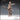 32mm resin miniature render of a human female fighter in studded leather armour, one arm extended pointing forward, holding a longsword low in her other hand with a flail hanging from her belt — Human Female Fighter 01 by Novaminis