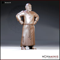 Heavyset bald barman standing with both hands on hips, wearing a long apron with a twisted rope tie at the waist, short beard, and a tunic clasped at the collar. Sculpt by Novaminis.