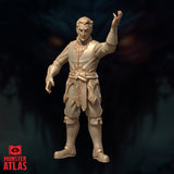 Front-facing digital render of the Male Wizard Tenser miniature at 32mm scale — unpainted resin in warm gold tone, wearing ornate embroidered robes with scrollwork detailing, right arm raised mid-incantation with fingers spread, left arm lowered, stern expression, Monster Atlas branding visible in lower left corner