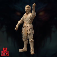 Side-angled digital render of the Male Wizard Tenser miniature — unpainted resin showing the full silhouette from a slightly lower angle, ornate lacework trim on tunic and lower panels clearly visible, right arm raised, left arm lowered, Monster Atlas branding in lower left corner