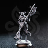 Unpainted grey resin miniature of The Matriarch tiefling noblewoman — front three-quarter view showing full sculpt detail including layered pauldrons, knotwork tabard coat, and decorative round base with scroll motifs