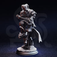 Three-quarter front view digital render of The Travelling Jack miniature showing detail of the star-void eye sockets on the jester skull mask, skeletal hands on the lute strings, crosshatch-quilted cape, and gargoyle base sculpt