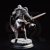 Armoured warrior mid-stride with longsword levelled forward and kite shield raised, wearing full plate over chainmail, horned pauldron, and billowing cape. Sculpt by DM Stash.
