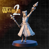 Tiefling warlock with small curling horns, one arm raised holding a crystal-tipped staff aloft, second staff gripped at her side, wearing layered robes with a braided belt. Sculpt by DnD Is A Woman.