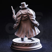 Rear view of the unpainted grey resin Torgrik Tall Hat miniature — showing the full sweep of his longcoat with detailed fabric folds, one pistol raised, and the ornate decorative base beneath him.