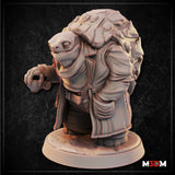 Tortle detective miniature shown at table scale next to a large d20, stocky build with open coat and heavy shell, broad reptilian face with half-closed eyes. Sculpt by Mia Kay M3DM.