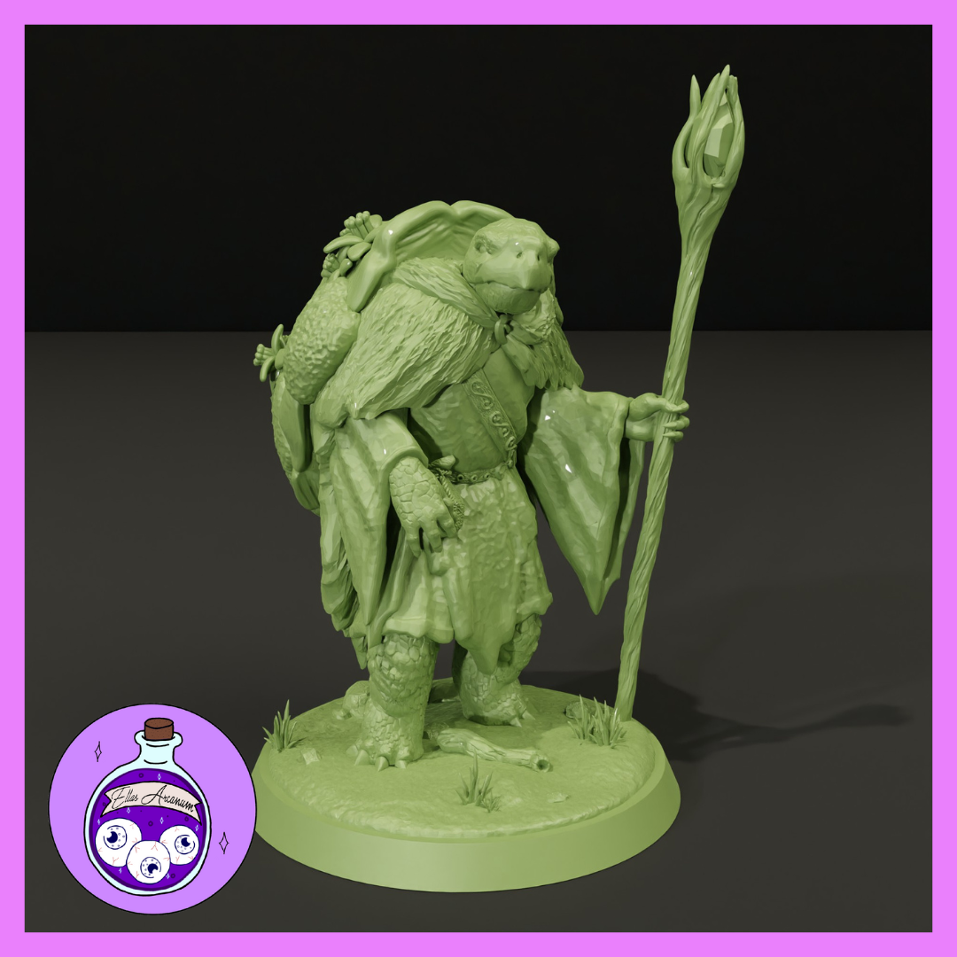 Digital render of an unpainted green resin male tortoisefolk druid miniature at 32mm scale, holding a tall gnarled staff topped with a leafy gem, wearing layered robes and a heavy cloak, with a large pack and small creatures on his back, standing on a textured base with grass tufts and fallen branches