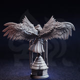 Unpainted grey resin miniature of Varathos angel warrior — rear view showcasing the extraordinary feather detail across the fully spread dark wings and the draped robes, with chains visible on either side of the stone tower base