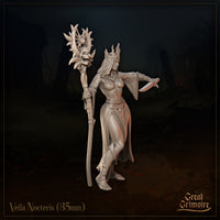 Three-quarter front view of Veila Nocteris 35mm resin miniature render — showing her flame-like iron crown, billowing sleeves, dagger grip, and the detailed skull and eye-motif atop her tall staff, by Great Grimoire