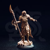 Front view of the unpainted Vendimar Thyran 32mm resin miniature on a round black base, photographed against a dark background, showing the eight-pointed sunburst breastplate, outstretched gauntleted hand, and intricate halberd with vertebrae-like shaft detail