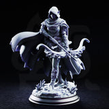 Hooded drow female ranger holding a longbow diagonally across her body, wearing layered plate armour with a billowing woven cloak, standing on a marsh scatter base. Sculpt by DM Stash.
