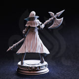 Rear three-quarter photograph of unpainted grey resin Vika 'Doll Lips' miniature — showing the full sweep of her long coat, back armour detail, and the engraved blades of the halberd raised overhead, on an ornate round display base