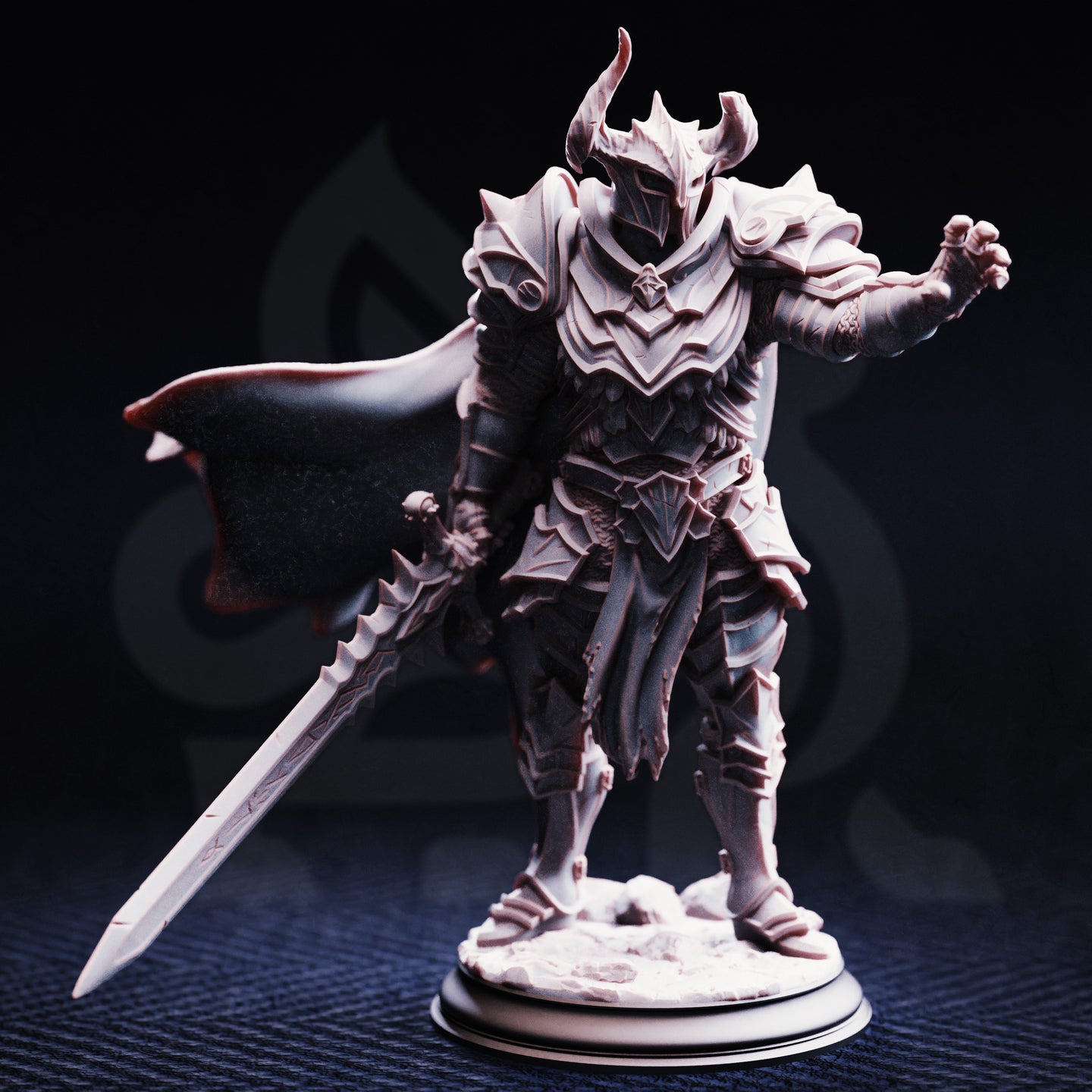 Photograph of Vilnais the Ashen unpainted grey resin miniature from the front — layered spiked plate armour, horned visor helm, runed longsword trailing at his side, right gauntlet raised, dramatic flowing cape, rocky base.