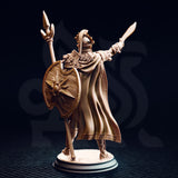 Unpainted resin miniature of Vilryn Kaedrys Sun Elf Gladiator, rear view — showing the laurel-bordered cloak, wood-grain textured round shield with sunburst boss, lion-head pauldron, and solar-crested helmet with plume
