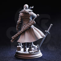 Rear view of the Vincent Nightingale unpainted grey resin miniature, showing his long flowing coat with knit texture, a large studded baton strapped across his back, a sword rising from the scenic base beside him, and additional scattered bottles and rope detail on the base.