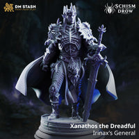 Rear view of Xanathos the Dreadful by DM Stash showing a large flowing cloak with finely sculpted woven fabric texture, spiked pauldrons visible above, cracked stone scenic base below.