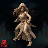 Yuan-Ti Pureblood female miniature in a forward lunging pose, holding a curved dagger in her right hand and a second blade in her left, wearing flowing robes with a serpent-scale pauldron and ornate gauntlets, with a jewelled third eye on her forehead — unpainted cream resin render by Monster Atlas