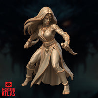 Front-facing view of a Yuan-Ti Pureblood female miniature, both daggers raised in a combat-ready stance, long hair swept to one side, scale-armoured shoulder guard and carved gauntlets visible — unpainted cream resin render by Monster Atlas