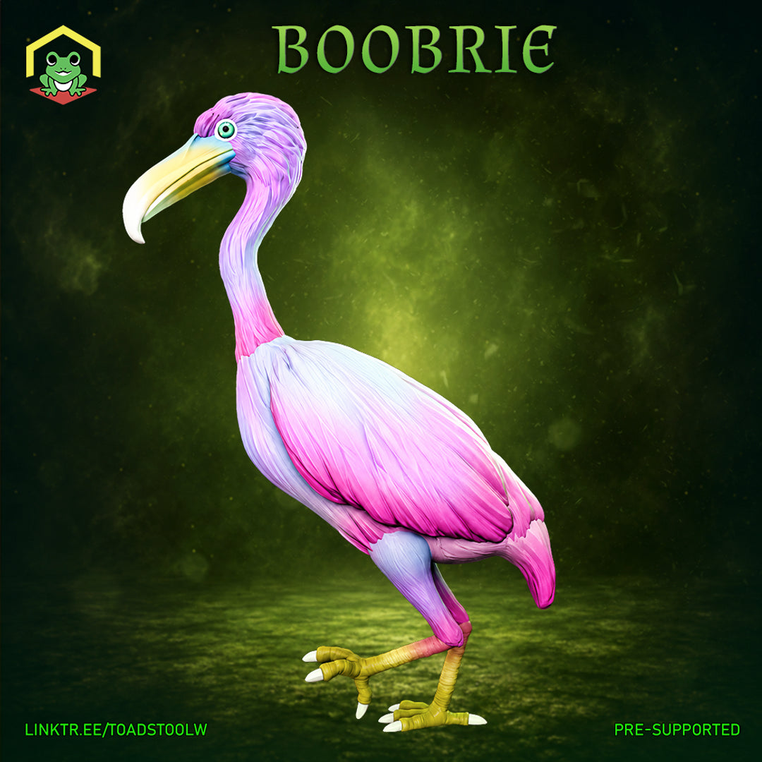 Boobrie miniature by The Toadstool Weaver — a tall wading bird with pink and lilac plumage, hooked yellow-green beak, and a single teal eye, standing upright with layered feather detail across the body and wings.