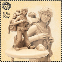 Unpainted resin miniature of a female gnome tinkerer at 32mm scale, shown in a confident relaxed pose gripping her pack strap. She wears aviator goggles on her head, a utility belt with pouches, and carries an overstuffed adventurer's pack loaded with a small chest and coiled rope. A close-up inset shows her mischievous grinning expression in detail. Sculpted by Mia Kay M3DM.