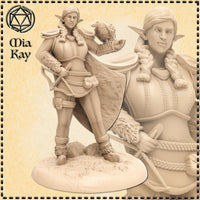 Unpainted cream resin Firbolg Ranger miniature by Mia Kay M3DM — female half-giant elf with long braided hair, scaled leather bracers, crossbow held at hip, and a hooded falcon perched on her outstretched gloved hand. Flowing travel cloak, feathered boots, and a textured rocky base. 32mm scale digital render shown with a close-up detail inset of the face and upper torso.