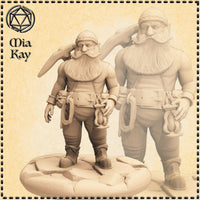 Digital render of an unpainted dwarf miner miniature at 32mm scale, sculpted by Mia Kay M3DM. The stocky male dwarf stands confidently with a dagger resting over his right shoulder, a heavy tool belt hung with coiled rope and climbing gear around his waist, and a large braided beard and moustache. He wears a close-fitting cap and sturdy boots. The miniature is shown on a detailed scenic base with a larger background render for scale reference.
