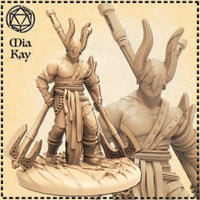 Unpainted cream resin 3D printed miniature of the Barbarian King by Mia Kay M3DM — a broad-shouldered male warrior in layered wrappings, sash, and scale mail, wearing a tall horned ceremonial helm. He holds two ornate twin-bladed axes with knotwork engravings, standing in a battle-ready pose on a rocky debris base. A close-up inset shows the horned helm and upper torso detail. Printed at 32mm scale by Mitz and Simz.