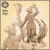 Unpainted cream resin render of a female Dragonborn Wizard miniature at 32mm scale, shown in two views: a close-up of her horned draconic head and ruffled collar, and a full-body pose with one arm raised mid-cast and the other gripping a gnarled wooden staff, standing on a swirling magical energy base with curling tendrils. Sculpted by Mia Kay M3DM.