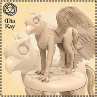 Unpainted cream resin baby hippogriff miniature shown from two angles — front view and three-quarter rear view. The sculpt features an eagle head with large round eyes and a hooked beak, layered feathered wings spread slightly, scaled breast feathers, smooth equine hindquarters with a flowing tail, and taloned forelegs gripping a detailed rocky base. Printed at 32mm scale by Mitz and Simz.