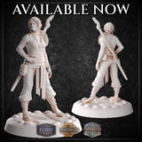 Front and rear views of an unpainted female elf monk miniature by M3DM, showing flowing sash details, spiral rune tattoos on her torso, and a twisted flame-topped staff across her back, on a cobblestone base