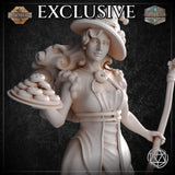 Close-up bust view of the unpainted white Dessert Witch miniature by Mia Kay M3DM, highlighting her knowing half-smile, wide curling witch hat with pastry charms, donut brooch necklace, ruffled neckline, and the detailed plate of stacked iced biscuits she holds aloft