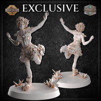 Two unpainted white resin Autumn Elf miniatures shown side by side — front and rear views — both in a dynamic dancing pose with one leg raised and arms spread wide. Both stand on detailed bases scattered with crystal formations and grass tufts, displaying the leaf-layered outfit and voluminous curly hair from multiple angles.