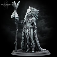 Rear view of an orc shaman, showing a dense cascade of braided locks and layered feathers forming a wide headdress, one hand raised to grip a skull-crowned staff beside her. Stormborn Collectibles sculpt.