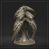 Three-quarter side view of the feathered angel miniature, showing layered wing detail, ornate armoured breastplate, scale-mail skirt, skull in one hand, and rune-etched sword resting beside her. By Dungeons & Maidens.